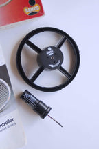 Close-up view of the black BAMBO mechanical string tension tester wheel and its accompanying calibrated metal pin gauge tool.