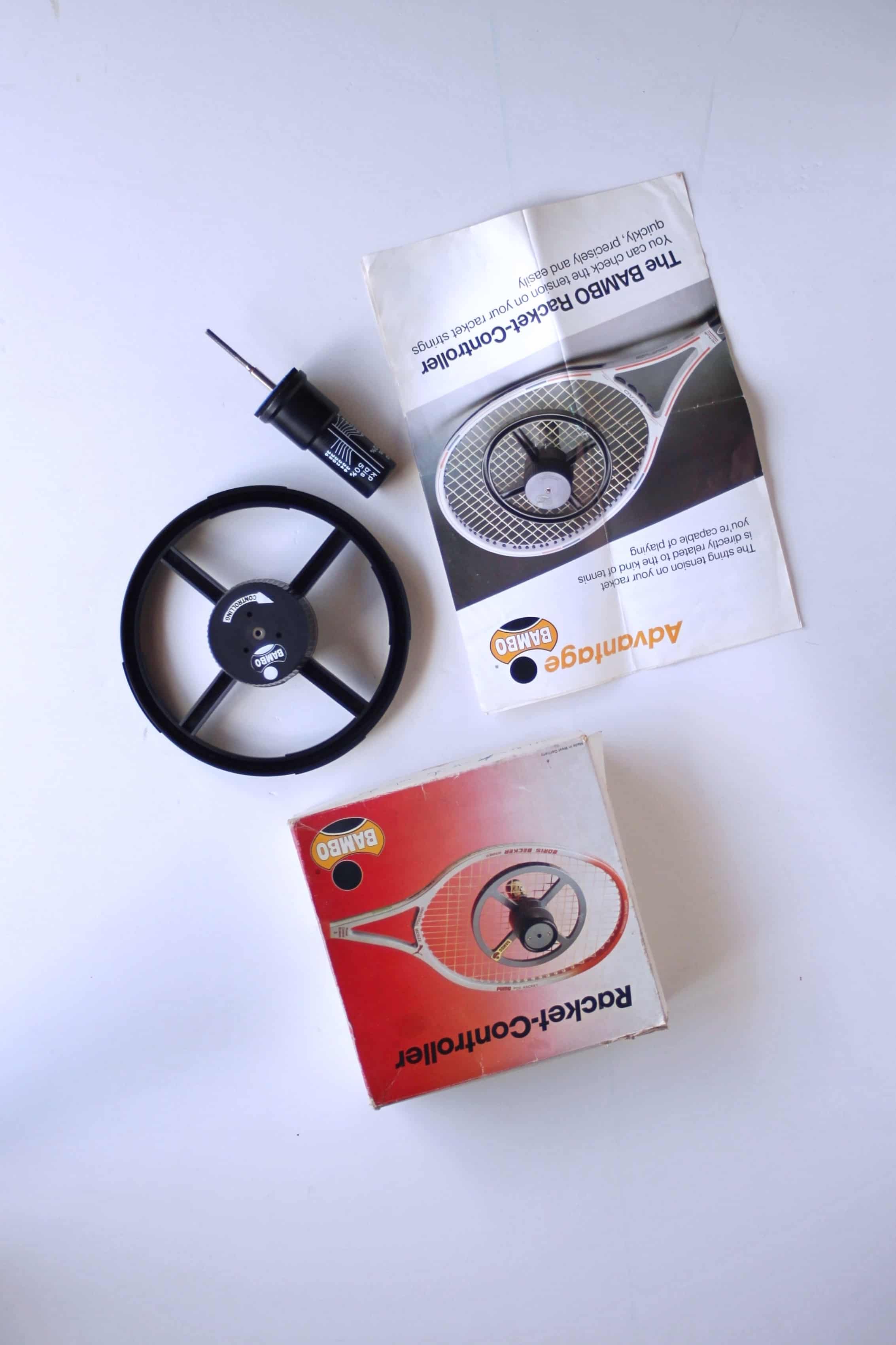 Full product set of the vintage deadstock BAMBO Racket-Controller tension tester, including the wheel unit, manual, tension gauge tool, and original box.