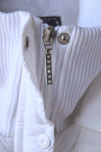 Detail shot of a ribbed collar of a  sleeveless puffer vest, showcasing the crystal embellished zipper.
