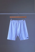 heather ash vintage 90s BODY WRAPPERS bike shorts on a hanger against a gray background.