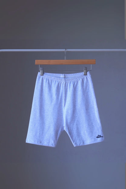 heather ash vintage 90s BODY WRAPPERS bike shorts on a hanger against a gray background.
