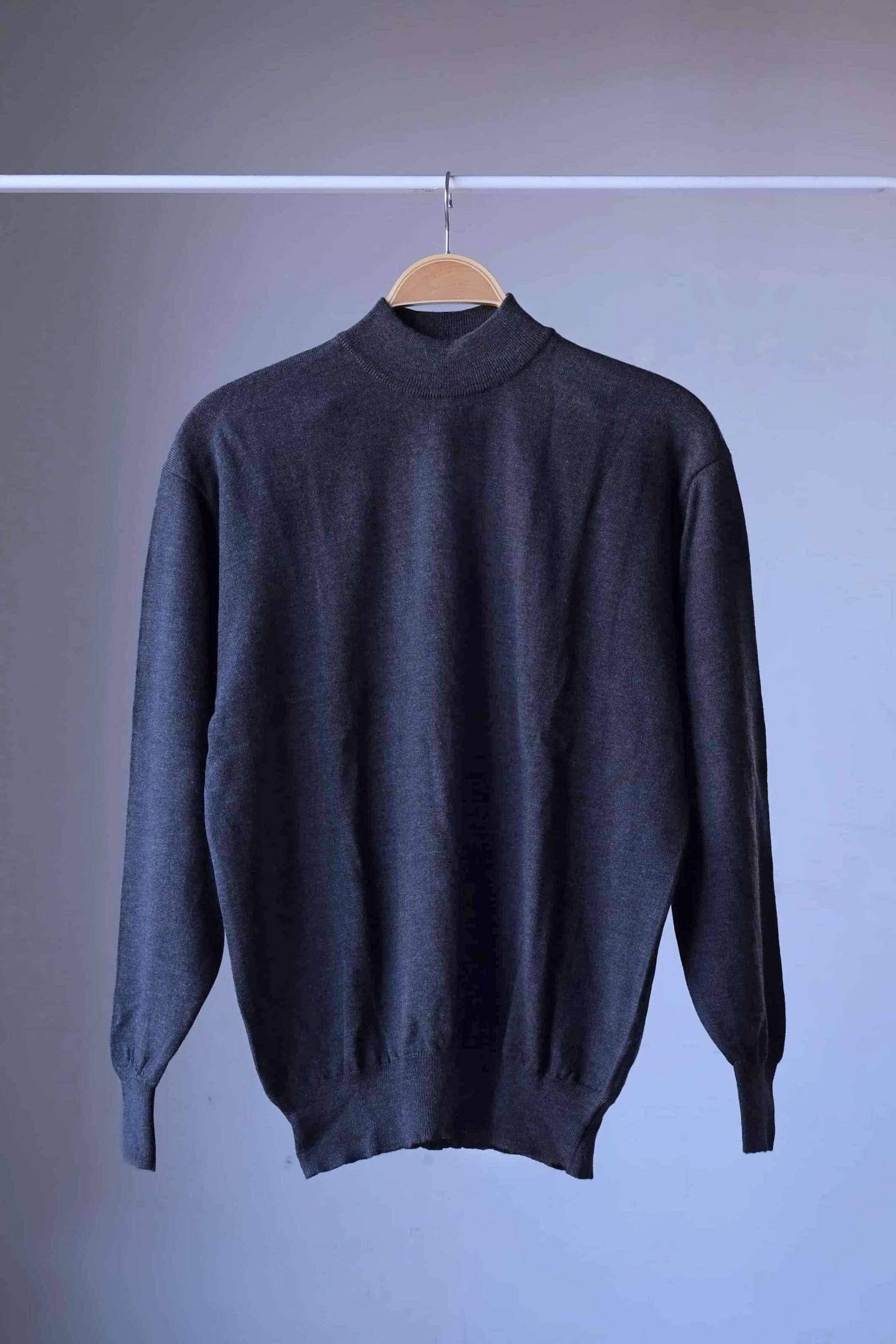 Front view of a single heather charcoal vintage Cagi pure wool high-neck sweater on a hanger.