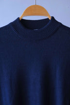 Detailed close-up of the ribbed high-neck collar on the navy vintage Cagi pure wool sweater.