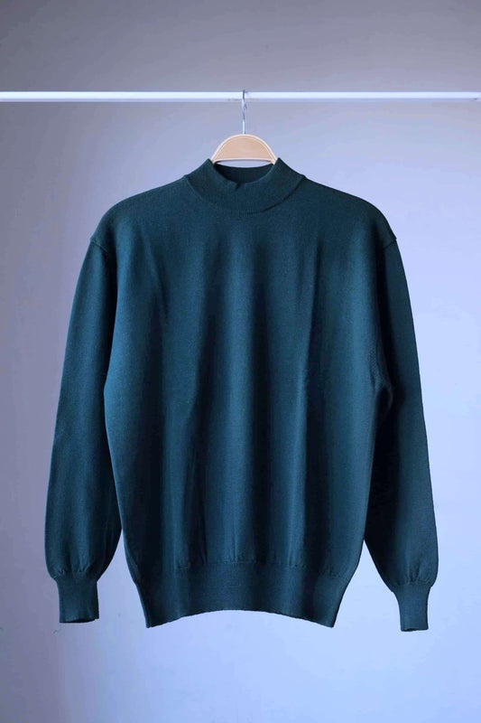 Front view of a single dark green vintage Cagi pure wool high-neck sweater on a hanger.