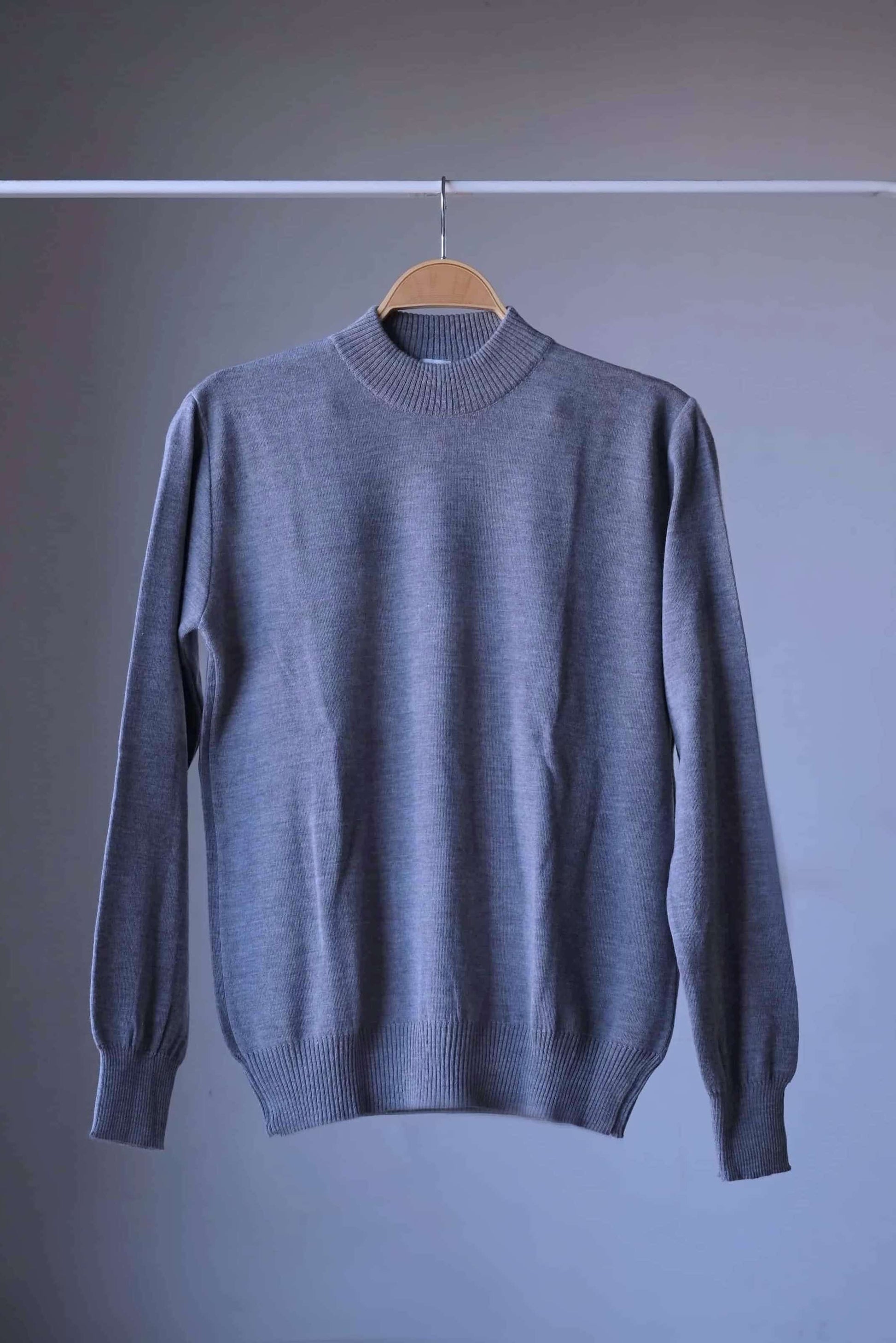 Full view of a single heather gray vintage Cagi pure wool high-neck sweater on a hanger.