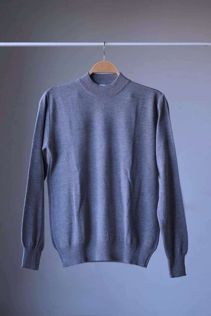 Full view of a single heather gray vintage Cagi pure wool high-neck sweater on a hanger.