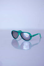 Three-quarter view of vintage Cébé aviator sunglasses in forest green with navy blue accents and original lens sticker.