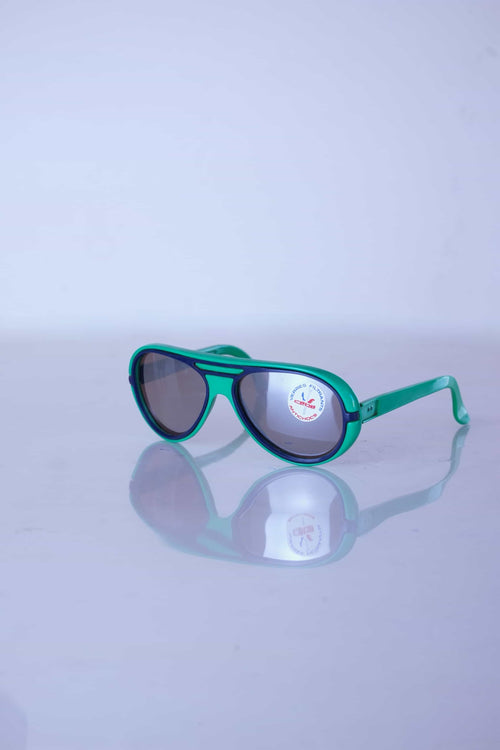 Three-quarter view of vintage Cébé aviator sunglasses in forest green with navy blue accents and original lens sticker.