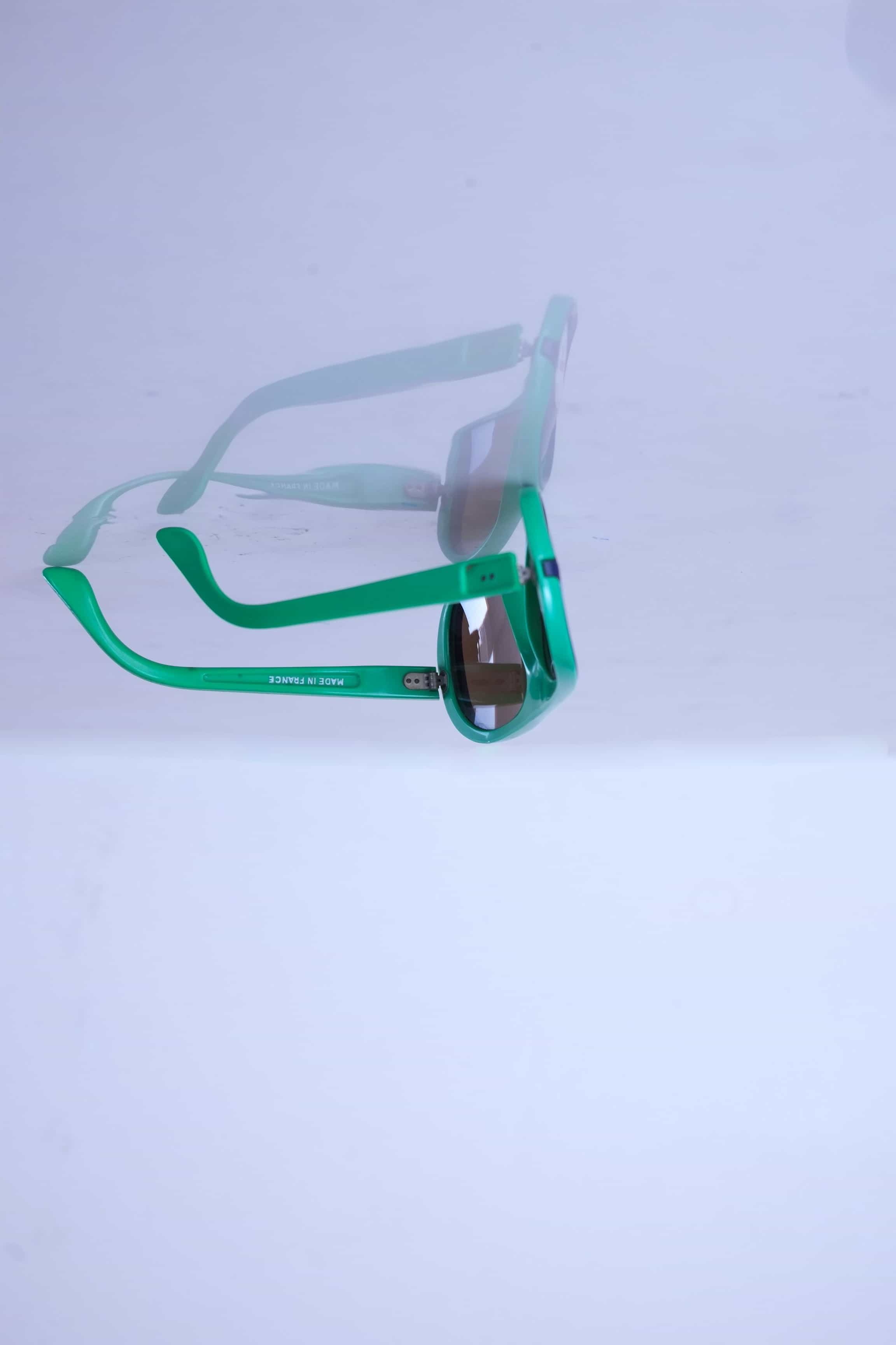Side profile of green retro Cébé sunglasses showing the lightweight nylon frame construction and storage-related temple curve.