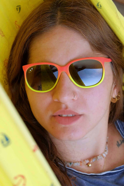 model wearing CÉBÉ neon orange and yellow Vintage Mirrored Sunglasses