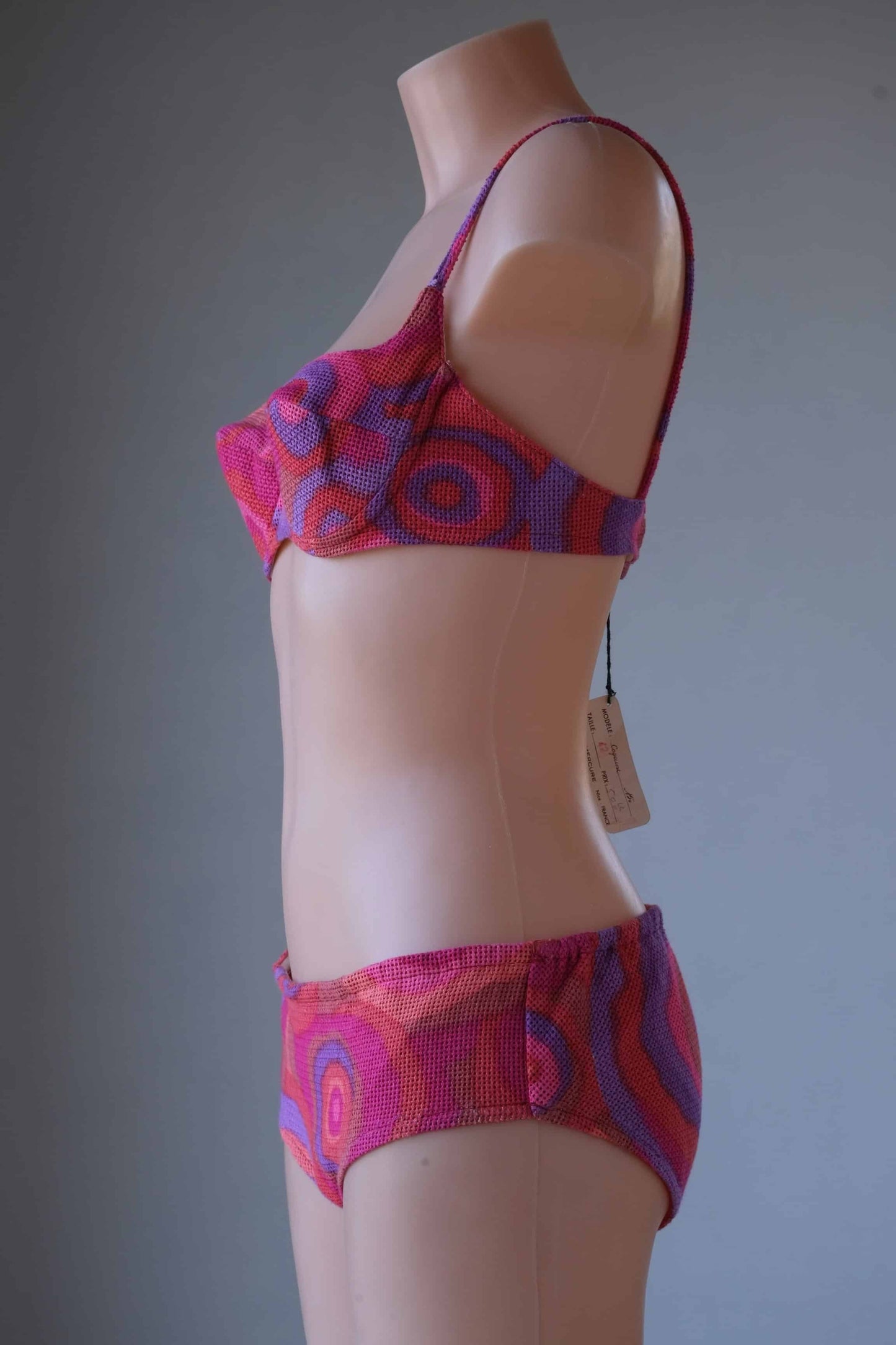 Multi pink pattern  Vintage 60's Crochet Bikini on mannequin from the side