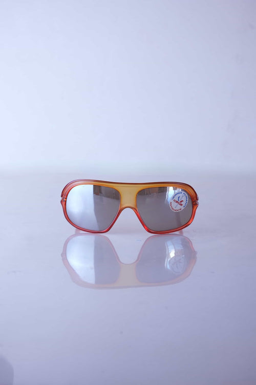 Front view of vintage Cébé amber translucent sunglasses with mirrored shield lenses and original factory lens sticker