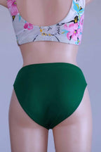 Back view of a mannequin wearing the vintage Danskin emerald green dance briefs.