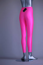 Back view of A mannequin wearing a pair of shiny neon pink vintage 90s Danskin high-waist leggings.