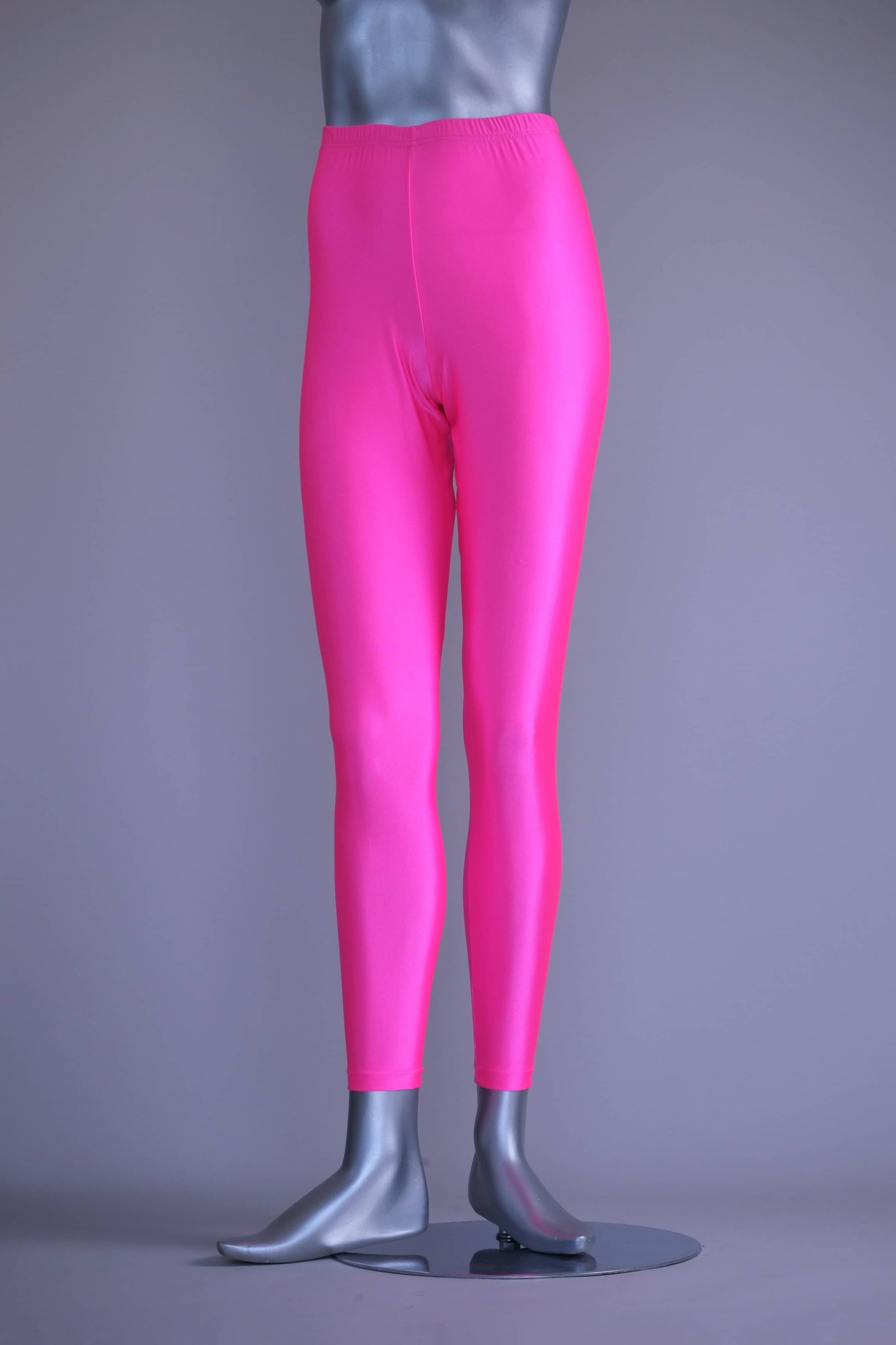 Front view of A mannequin wearing a pair of shiny neon pink vintage 90s Danskin high-waist leggings.