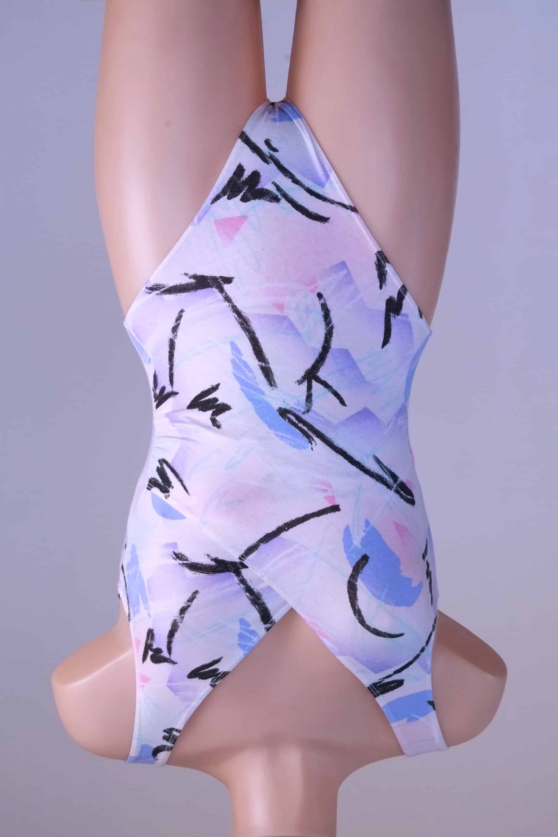 Front view of a vintage Danskin leotard with a pastel abstract print on a mannequin.