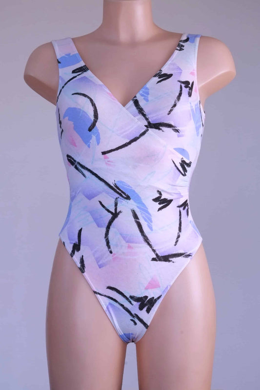 Front view of a vintage Danskin leotard with a pastel abstract print on a mannequin.