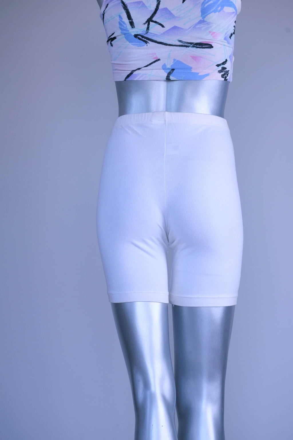 A pair of Vintage 90s white cotton biker shorts displayed on a silver mannequin, front view.
