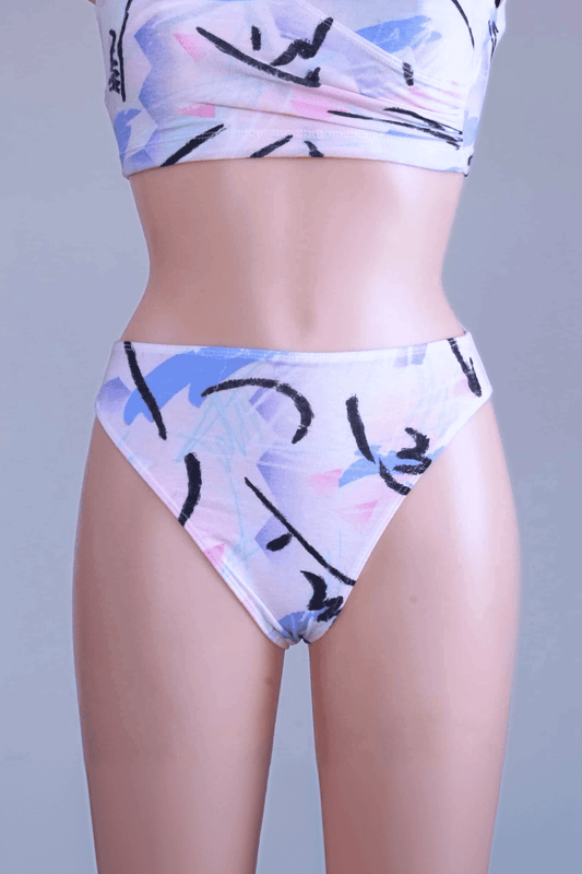 A pair of vintage 90s DANSKIN dance briefs with a white base and blue, purple, and black pastel print, worn by a mannequin.