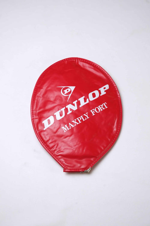 Red vintage vinyl Dunlop Maxply Fort tennis racket head cover with white branding and zipper enclosure, isolated on a white background.