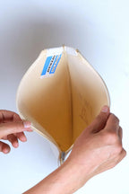 Two hands opening a vintage white vinyl Dunlop tennis racket cover to display the clean cloth interior lining and authentic Made in England tag.