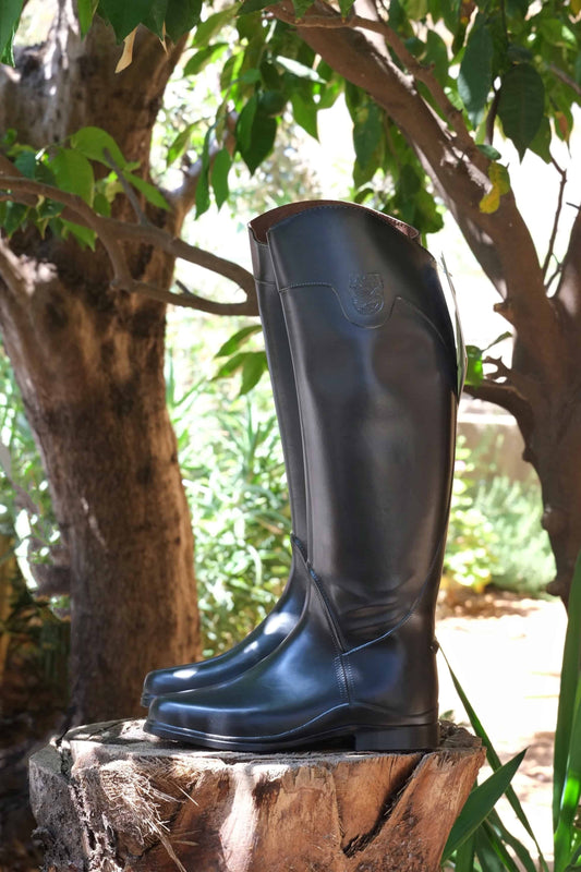 AIGLE Ecuyer Pro Horseback Riding Boots potographed outside on a tree trunk