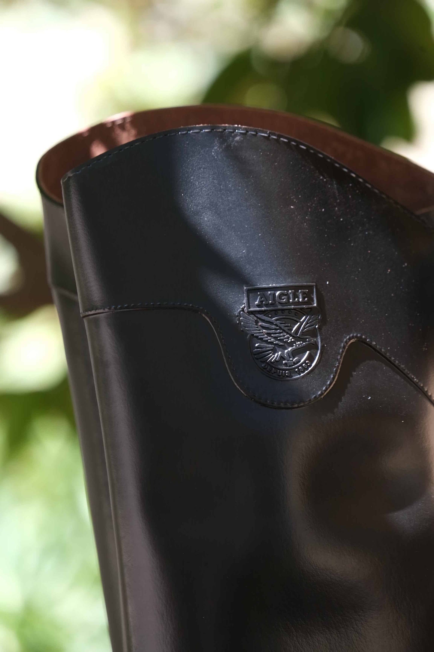 AIGLE Ecuyer Pro Horseback Riding Boots detail shot of the emblem on the boot cuff