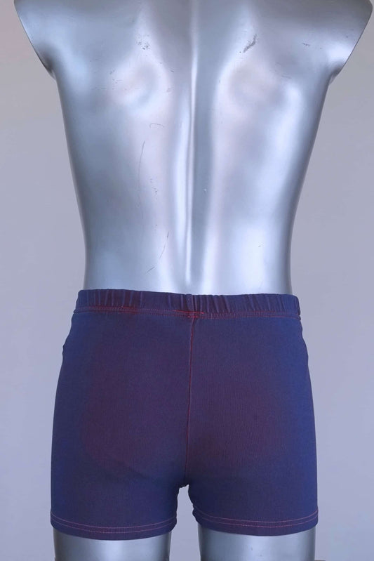 Back view of vintage 90s Ellesse men’s swim trunks in purple ribbed fabric, displayed on mannequin.