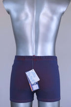 Back view of vintage Ellesse swim trunks showing original paper tags attached at waistband.