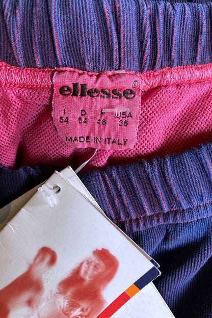 Close-up of pink Ellesse size tag reading 54 Italy, 38 USA, made in Italy.