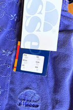 Closeup of Ellesse tag showing product code, style, and size information.