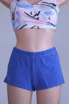 Front view of mannequin wearing vintage Ellesse embroidered terry hot pants in blue.