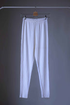 High-waisted, ribbed white leggings hanging on hanger.