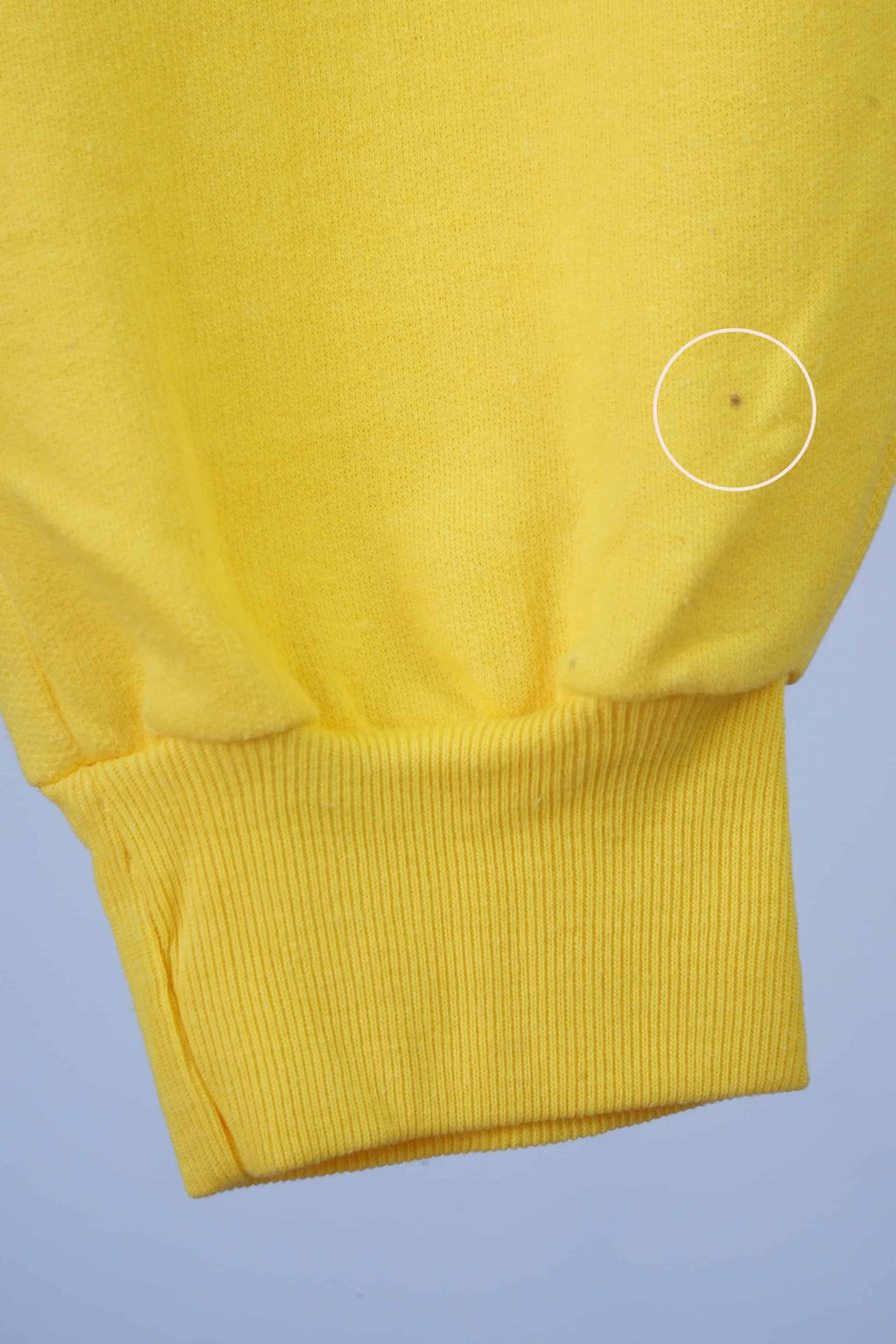 Close up of the hem of yellow vintage fila 90s sweatpants.