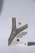 Deadstock vintage Fischer Vibrastop tennis stringbed vibration dampener, displayed on its original retail card featuring retro branding.