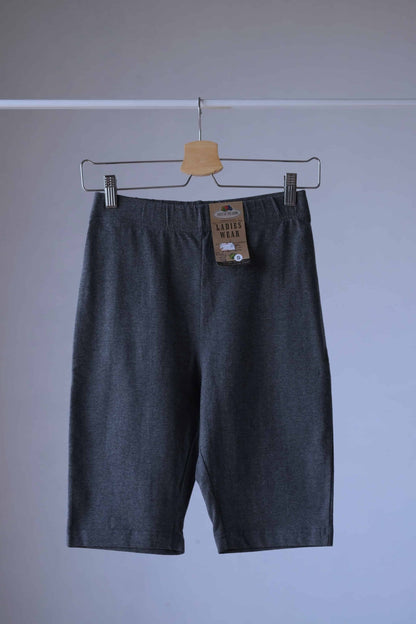 Heather charcoal Fruit of the loom  Ladies Wear biker shorts hanging on a hanger. The shorts have an elastic waistband and are made of a soft, stretchy fabric. The tag is visible on the waistband.