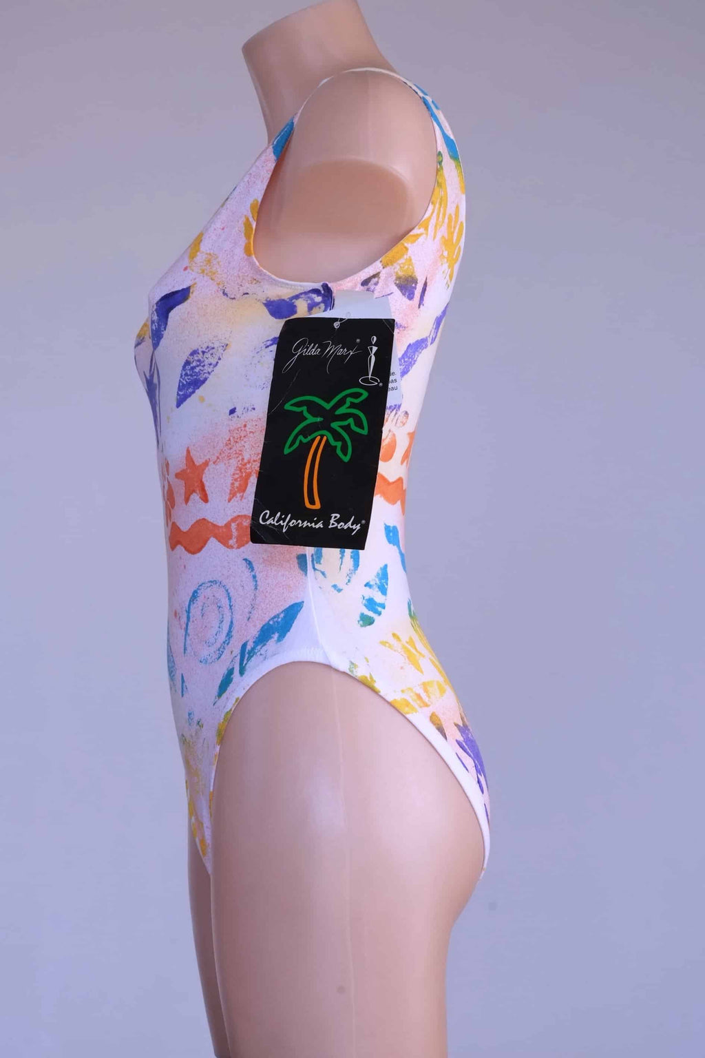 Side view of the vintage Gilda Marx leotard with the tag still attached, showing the full design.