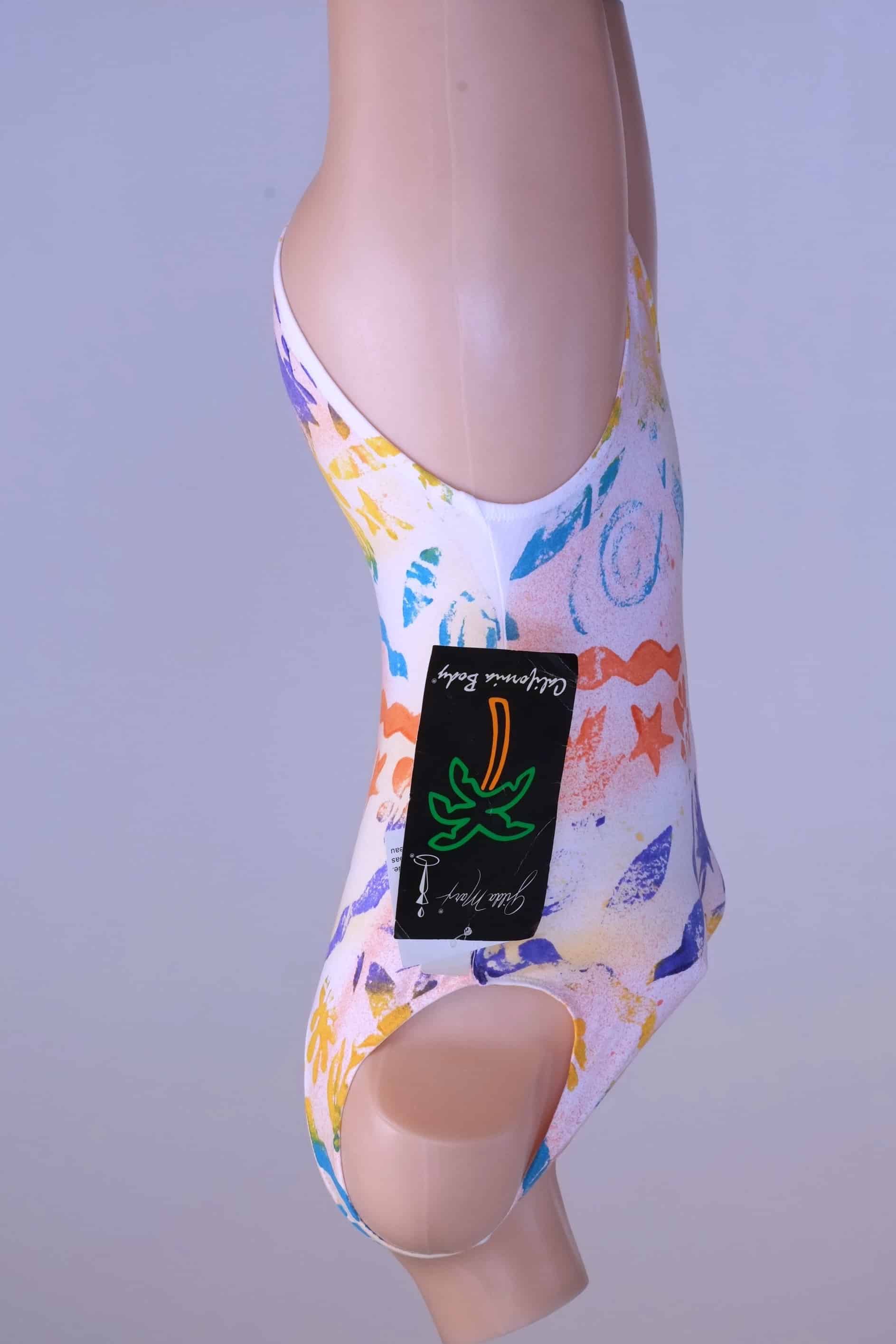 Side view of the vintage Gilda Marx leotard with the tag still attached, showing the full design.