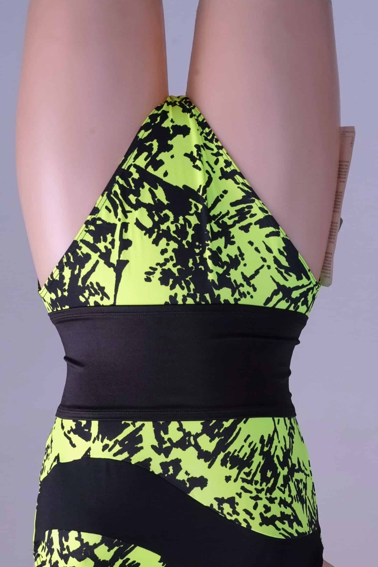 A black vintage Gilda Marx waistband styled over a neon yellow and black printed leotard on a mannequin.