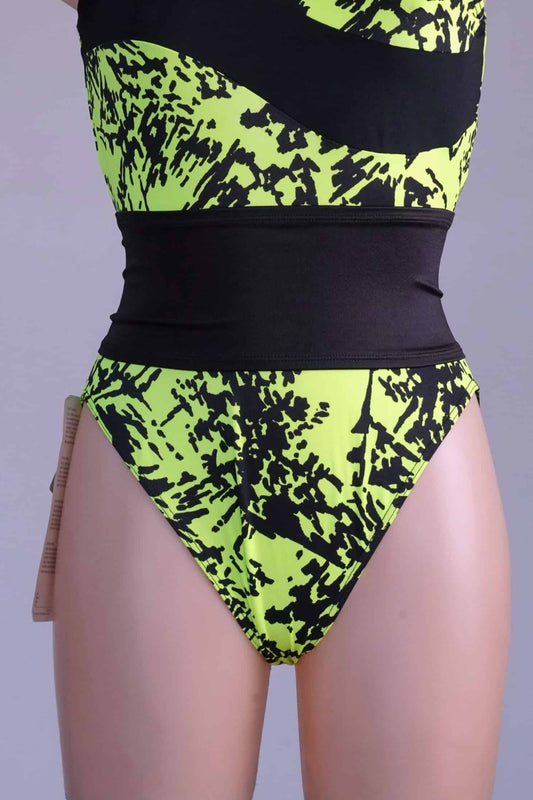 A black vintage Gilda Marx waistband styled over a neon yellow and black printed leotard on a mannequin.