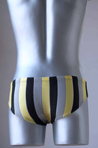 JACKY PEER Vintage black, grey and yellow Striped Swim Briefs worn by mannequin, photographed from behind.