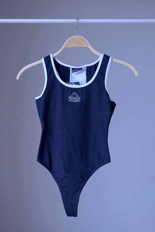 Front view of a navy KAPPA vintage 90s women's activewear leotard with white trim and a chest logo, displayed on a wooden hanger.