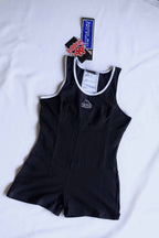 A black KAPPA vintage 90s women's activewear biketard with white trim and a KAPPA logo on the chest, laid flat with original tags visible.