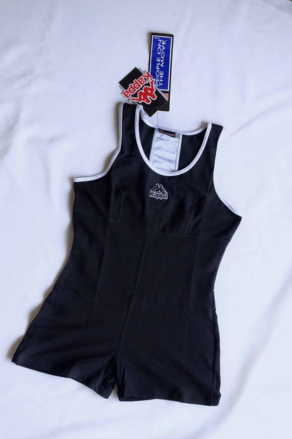 A black KAPPA vintage 90s women's activewear biketard with white trim and a KAPPA logo on the chest, laid flat with original tags visible.