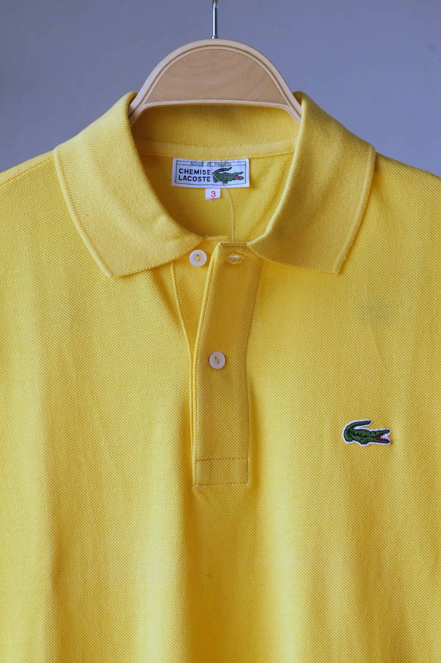 Close up of LACOSTE 80's Retro Polo Shirt in yellow