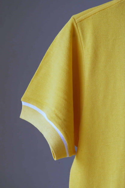 Detail of a sleeve of LACOSTE 80's Retro Polo Shirt in yellow