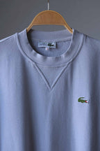 close up of Gray Lacoste 90s sweatshirt on hanger