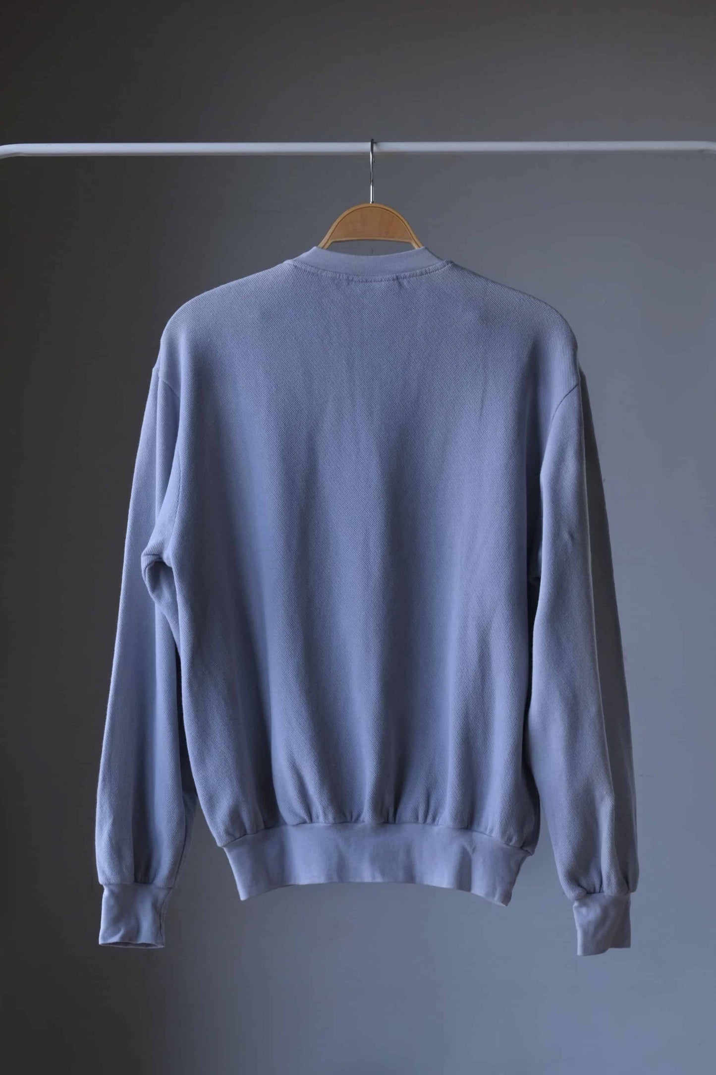 backside of close up of Gray Lacoste 90s sweatshirt on hanger