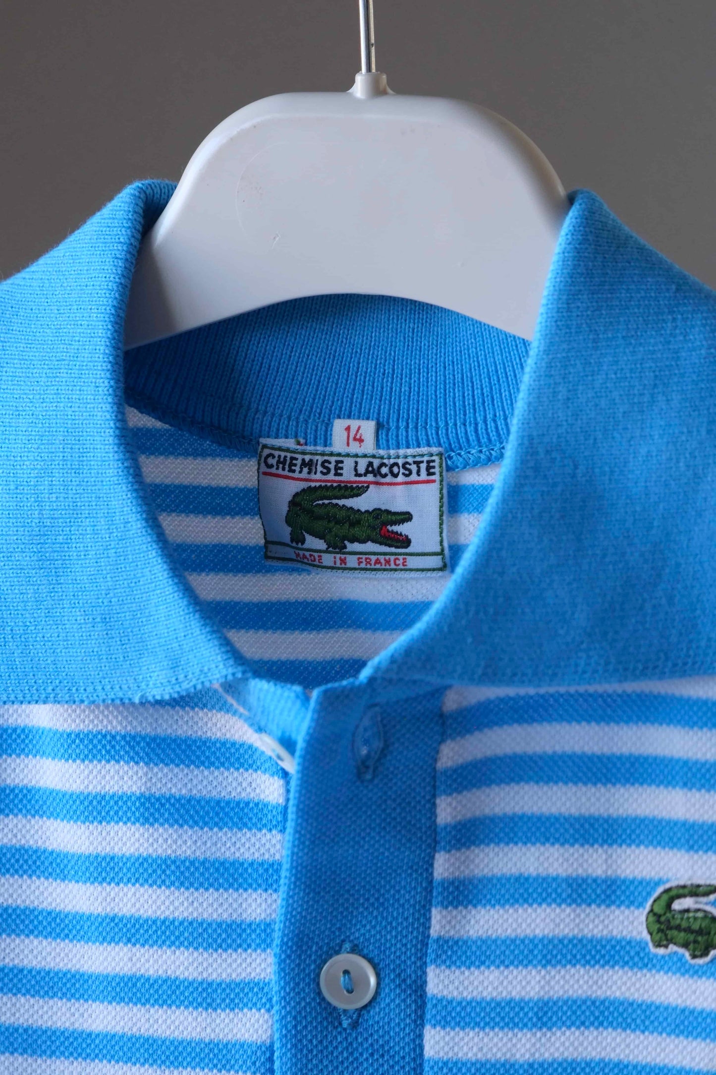 LACOSTE Kids Polo in white and bright blue stripes close up of tag