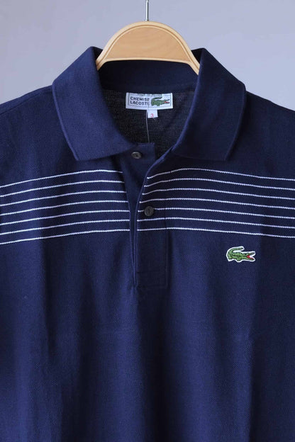close up of LACOSTE Retro Polo in navy with white stripes photographed on hanger